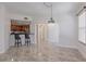 View of the kitchen and bar stool seating from the living room and adjacent hallway at 16572 San Edmundo Rd # 111, Punta Gorda, FL 33955