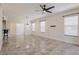 Living room with tile floor, neutral paint, large windows, and an arched doorway at 16572 San Edmundo Rd # 111, Punta Gorda, FL 33955