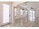 Bright open-concept living space featuring tile floors and a sliding glass door to the backyard at 16572 San Edmundo Rd # 111, Punta Gorda, FL 33955