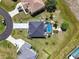 Aerial shot of home with long driveway, dark roof and screened pool in a well-manicured neighborhood at 17304 Vagabond Cir, Punta Gorda, FL 33955