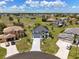 Aerial view featuring the home, manicured lawns, and a spacious driveway in a desirable neighborhood at 17304 Vagabond Cir, Punta Gorda, FL 33955
