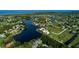 An aerial view of a waterfront community with residences lining the shore of a dark, winding lake at 17304 Vagabond Cir, Punta Gorda, FL 33955