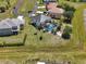Aerial view of a landscaped backyard with a dark roof and a screened pool at 17304 Vagabond Cir, Punta Gorda, FL 33955