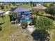 Aerial view of the home with a screened pool, lush landscaping, and a well-maintained yard at 17304 Vagabond Cir, Punta Gorda, FL 33955
