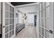 View of bedroom with wood floors, natural light, and glass paneled doors at 17304 Vagabond Cir, Punta Gorda, FL 33955