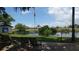 A picturesque lake with benches, chairs and green space are the focus of this pleasing view at 17304 Vagabond Cir, Punta Gorda, FL 33955