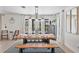 Charming dining room with a rustic table, bench seating, decorative lighting, and windows providing abundant natural light at 17304 Vagabond Cir, Punta Gorda, FL 33955