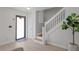 Bright entryway showcasing light wood flooring, stairs with white banister, and decorative potted plant at 17304 Vagabond Cir, Punta Gorda, FL 33955