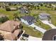 Aerial view of a two story home with a dark roof, light colored stucco, and a long driveway at 17304 Vagabond Cir, Punta Gorda, FL 33955