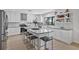 Bright, modern kitchen with white cabinetry, granite counters, and a center island with seating at 17304 Vagabond Cir, Punta Gorda, FL 33955