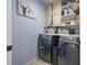 Well-organized laundry room with front-load washer and dryer, ample storage, and stylish decor at 17304 Vagabond Cir, Punta Gorda, FL 33955