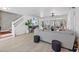Open-concept living room features a staircase and seamless flow into the dining area at 17304 Vagabond Cir, Punta Gorda, FL 33955