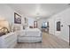 Bright main bedroom featuring hardwood floors, TV, and a large, comfortable bed at 17304 Vagabond Cir, Punta Gorda, FL 33955