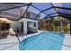 View of the pool and screened in patio, with additional seating at 17304 Vagabond Cir, Punta Gorda, FL 33955