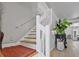 Bright staircase leads to upper level, complemented by a lush potted plant and decorative accents at 17304 Vagabond Cir, Punta Gorda, FL 33955