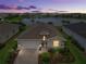 Aerial view of the home with a beautiful lake view and well-manicured lawn at 17620 Winding Wood Ln, Punta Gorda, FL 33982
