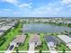 Aerial view of the community featuring homes surrounding a picturesque lake at 17620 Winding Wood Ln, Punta Gorda, FL 33982