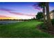 Beautiful backyard featuring a pond and well maintained lawn at 17620 Winding Wood Ln, Punta Gorda, FL 33982