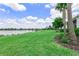 Beautiful backyard featuring a pond and well maintained lawn at 17620 Winding Wood Ln, Punta Gorda, FL 33982