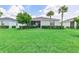 Well-manicured backyard with lush green lawn, perfect for outdoor activities at 17620 Winding Wood Ln, Punta Gorda, FL 33982