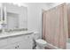 Clean bathroom with white vanity, granite countertop, tiled shower, and neutral color scheme at 17620 Winding Wood Ln, Punta Gorda, FL 33982