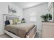 Cozy bedroom with a comfortable queen-size bed, decorative pillows, and a window with natural light at 17620 Winding Wood Ln, Punta Gorda, FL 33982