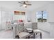 Bright bedroom with a ceiling fan, large bed, and a scenic lake view through the window at 17620 Winding Wood Ln, Punta Gorda, FL 33982