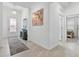 Inviting foyer with a decorative rug, chandelier, and stylish blue accent cabinet at 17620 Winding Wood Ln, Punta Gorda, FL 33982