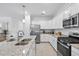 Stylish kitchen featuring granite countertops, stainless steel appliances, and modern lighting fixtures at 17620 Winding Wood Ln, Punta Gorda, FL 33982
