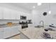 Well-equipped kitchen with granite countertops, stainless steel appliances, and white cabinetry at 17620 Winding Wood Ln, Punta Gorda, FL 33982
