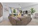 Spacious living room with a large sectional sofa, water view, and stylish decor at 17620 Winding Wood Ln, Punta Gorda, FL 33982