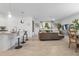 Open-concept living room with bar seating, sofa, and water view at 17620 Winding Wood Ln, Punta Gorda, FL 33982