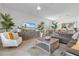 Open-concept living room with plush seating, TV, and stylish decor at 17620 Winding Wood Ln, Punta Gorda, FL 33982