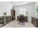 Bright home office featuring a modern desk, ample storage, and a large window for natural light at 17620 Winding Wood Ln, Punta Gorda, FL 33982