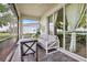 Relaxing covered patio with comfortable seating area and views of the beautiful lake at 17620 Winding Wood Ln, Punta Gorda, FL 33982