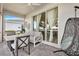 Relaxing covered patio with comfortable seating area, hanging chair and lake views at 17620 Winding Wood Ln, Punta Gorda, FL 33982