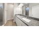Modern bathroom featuring a double granite vanity and a tiled shower at 18503 Ellen Ave, Port Charlotte, FL 33948