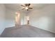 Large bedroom with a ceiling fan and doorway leading to an en suite bathroom and kitchen at 18503 Ellen Ave, Port Charlotte, FL 33948