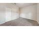 Empty bedroom featuring neutral carpet, baseboards, and closet with sliding doors at 18503 Ellen Ave, Port Charlotte, FL 33948