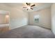 Bedroom featuring neutral carpet, ceiling fan, and natural light from a single window at 18503 Ellen Ave, Port Charlotte, FL 33948
