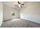 Spacious bedroom with neutral carpet, ceiling fan, and ample natural light at 18503 Ellen Ave, Port Charlotte, FL 33948
