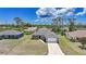 A well-manicured lawn and a concrete driveway leading up to an attached two car garage at 18503 Ellen Ave, Port Charlotte, FL 33948