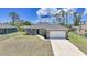 Beautiful single-story home features a gray exterior, well-maintained lawn, and an attached two-car garage at 18503 Ellen Ave, Port Charlotte, FL 33948