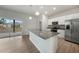 Modern kitchen with a granite island, stainless steel appliances, and a view to the outdoors at 18503 Ellen Ave, Port Charlotte, FL 33948