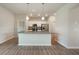 Open-concept kitchen with a large island, stainless steel appliances, and modern white cabinetry at 18503 Ellen Ave, Port Charlotte, FL 33948