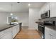 Modern kitchen featuring granite countertops, stainless steel appliances, and white cabinets at 18503 Ellen Ave, Port Charlotte, FL 33948