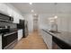 Stylish kitchen featuring stainless steel appliances, granite countertops, and bright white cabinetry at 18503 Ellen Ave, Port Charlotte, FL 33948