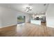 Bright, open living room with sliding glass doors, leading to an open kitchen with stainless steel appliances at 18503 Ellen Ave, Port Charlotte, FL 33948