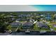 Home with screened pool and dock access to the waterway, surrounded by lush green landscaping at 19246 Moore Haven Ct, Port Charlotte, FL 33948