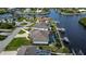 Beautiful aerial view of the home with its desirable waterfront location, private dock and pool at 19246 Moore Haven Ct, Port Charlotte, FL 33948
